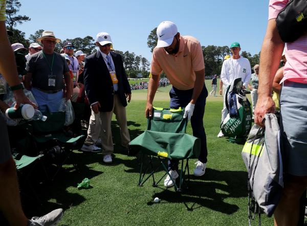 Scheffler moves a chair to get to his ball 